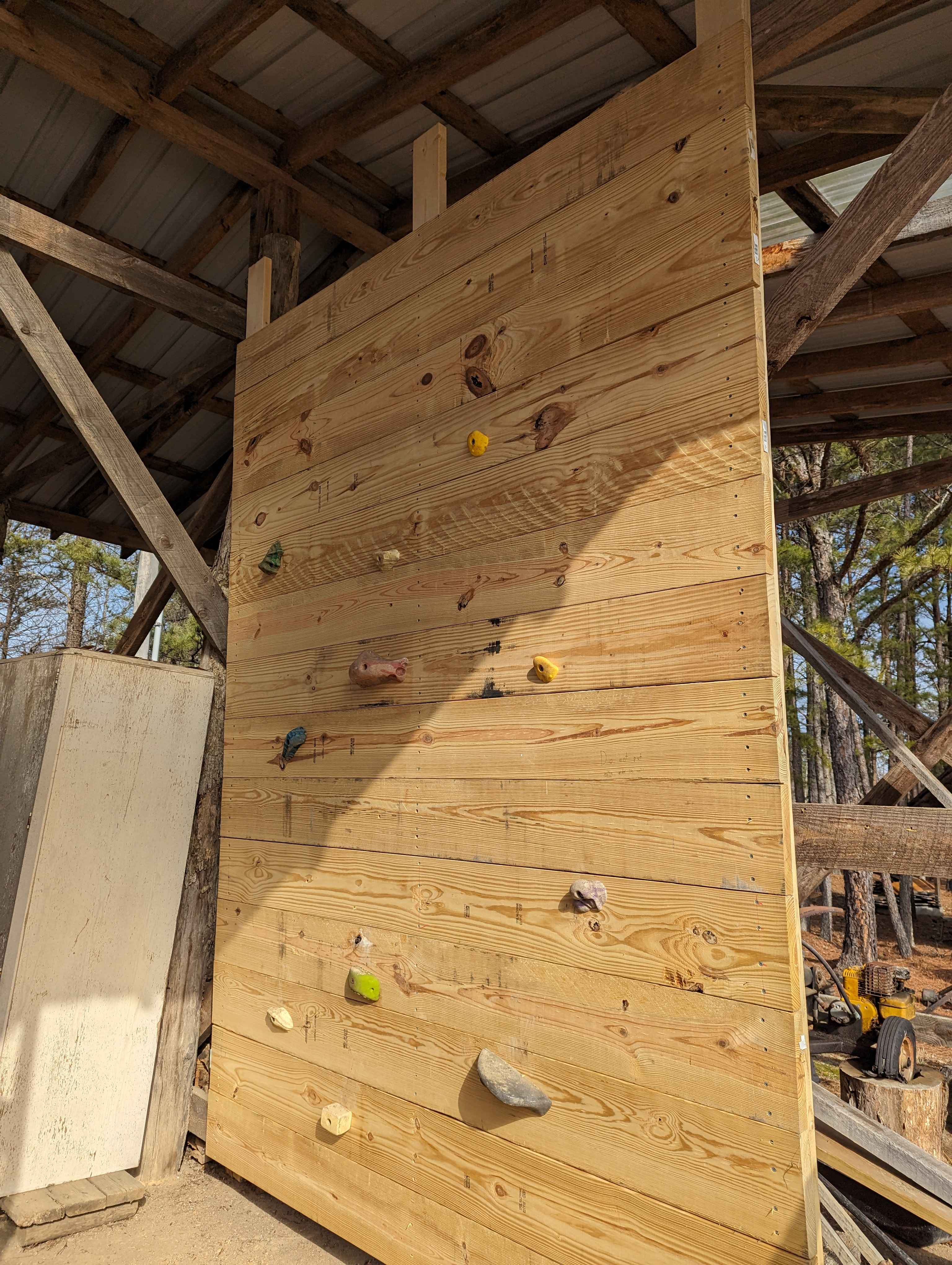 A rock wall made of wood in a shed