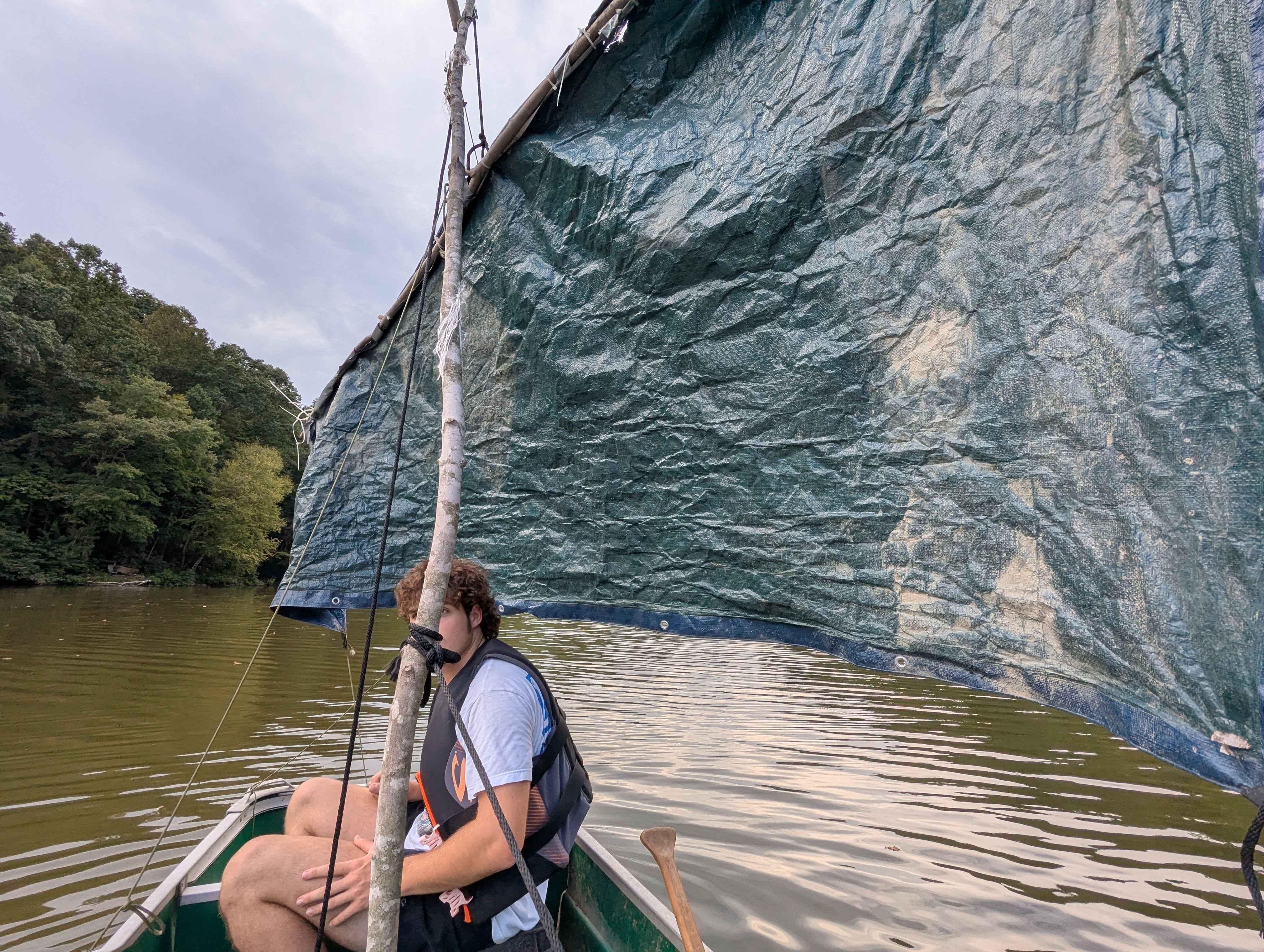 A fellow sitting in the previously pictured sailboat, but the sailplan has slightly changed.